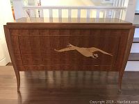 Full front view of Birds Eye maple credenza with inlaid swan design on front panel, showing overall shape and finish.