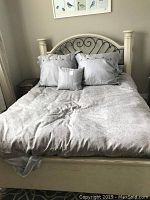 Queen size bed made up with the light gray patterned duvet cover and matching pillow shams and pillows