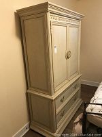 Full view of the wooden Thomasville armoire showing overall structure and size.