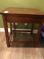 Front and side view of rectangular wooden printer or accent table showing the full structure including legs and cross supports