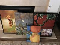 Four framed canvas pop art prints before wall, showing various floral themes