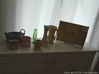 Photo of entire lot showing basket, various planters including McCoy items, vases and tray