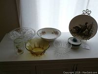 View of entire set on sideboard showing platter, bowls, dish and vase with natural light