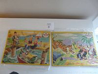 Two vintage cardboard Popeye puzzles side by side wrapped in plastic showing tape marks