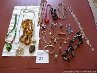 Full lot of assorted jewelry pieces arranged on table