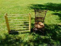 Photo showing the ornate wicker side chair alongside the wooden drying rack on grass outdoors.