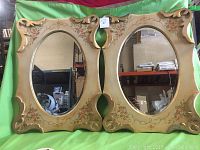 Perspective showing the front of the two hand painted beveled mirrors with floral accents and ornate frames.