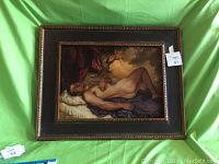 Full view of the framed vintage oil painting of a nude man reclining.