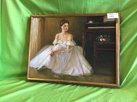 Full view of framed ballerina oil painting on green background, showing subject seated in white ballet costume with delicate off-shoulder sleeves.