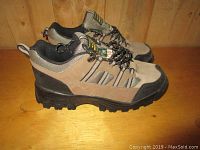 Side view of the pair of Alta steel toe work shoes showing beige suede and black rubber toe reinforcement with black sole.