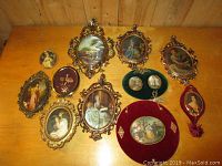 Collection of 11 Victorian style vintage framed pictures and music box shown on wooden table