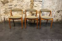 Front view showing three teak chairs in a row