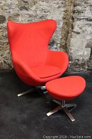 Front angle view of red egg style lounge chair with ottoman showing overall shape and condition