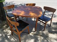 Full view of table and four chairs outdoors