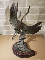 Front view of bronze bird sculpture in flight
