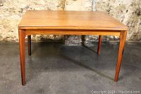 Front view of table showing rectangular top and tapered legs