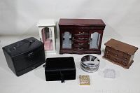 All jewelry boxes and containers displayed together on white surface showing variety of sizes and materials
