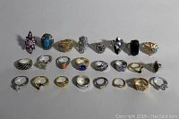 Photo of all 20 assorted ladies rings showing various stones, bands and styles.