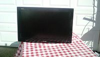 Front view of Sharp Aquos 32-inch television showing screen and brand logo below the screen.