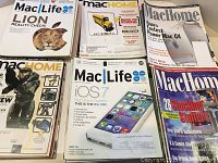 Photo showing six Mac magazines including Mac Life with Lion reality check and iOS 7, Mac Home with Power Mac G4 and game-related covers.