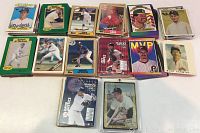 Photo showing a spread of various baseball cards featuring players in poses, some labeled with teams like Dodgers, Phillies, and others. Cards include bright colors and star players of the era.