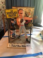 Front view of boxing figurine on metal base with Pabst Blue Ribbon bottle and sign