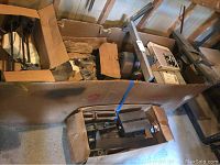 Two cardboard boxes containing cast iron table extension and other steel components