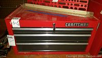 Front view showing closed 3 drawer Craftsman tool box with key in lock.