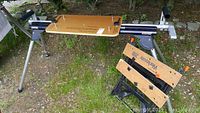 Black and Decker Workmate 200 work bench set up outdoors with foldable legs and wooden top with clamp handles.