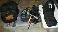 Overview showing multiple items including headphones, walkie talkies, storage boxes and a carrying case.