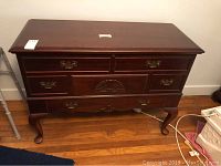 Front view of Lane cedar chest showing four drawers with brass handles and carved details on wooden front.