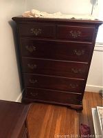 Front angle of Hungerford mahogany dresser showing six drawers, brass handles and dark wood finish.