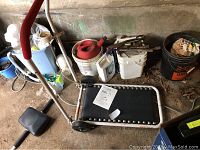 Folding treadmill and ab roller unit placed on the floor among other stored items.