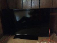 Front view of Samsung 40 inch flat panel TV on a stand, showing the full screen and bezel.
