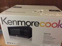 Box of a Kenmore countertop microwave oven showing the Kenmore cook logo and an image of the microwave.