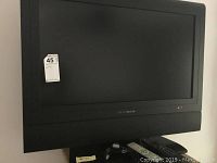 Front-facing shot of Lifestyles 30 inch TV with black frame, integrated speaker, and a sticker label on the top left corner.