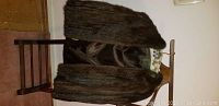 Front and partial interior view of J. P. Allen Atlanta mink fur jacket in brown fur hung on wooden chair.