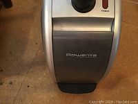Close-up of Rowenta Commercial branding on silver steamer unit with power button visible.