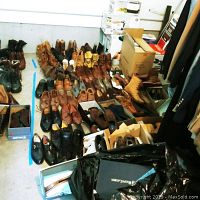 Overview of 26 pairs of men's shoes arranged on floor