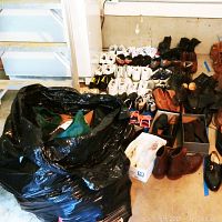 Wide view showing multiple pairs lined up with black bag at left