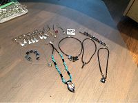 Photo of assorted necklaces and keychains arranged on a table showing variety of designs and styles.