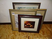 Six framed prints stacked, showing different frame styles and sizes