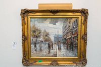 Full frontal view of framed oil painting with picture light mounted above.