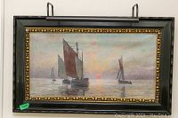 Full frontal view of framed oil seascape painting showcasing sailboats and decorative frame