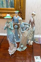 Front view of four Lladro figurines arranged on table