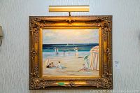 Full view of the framed oil painting showing beach scene with figures and sailboats