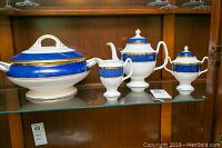 Set of four Coalport Athlone Blue fine china pieces displayed on glass shelf: tureen, coffee pot, creamer, and sugar bowl.