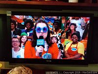 Photo showing Toshiba TV displaying a color image with people visible on the screen, confirming the TV is a color unit.