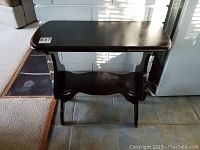 Front view of the vintage wooden side table showing rectangular top and lower shelf