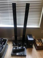 Full view of the Samsung surround sound speaker system, including two tall towers, subwoofer, and other speakers.